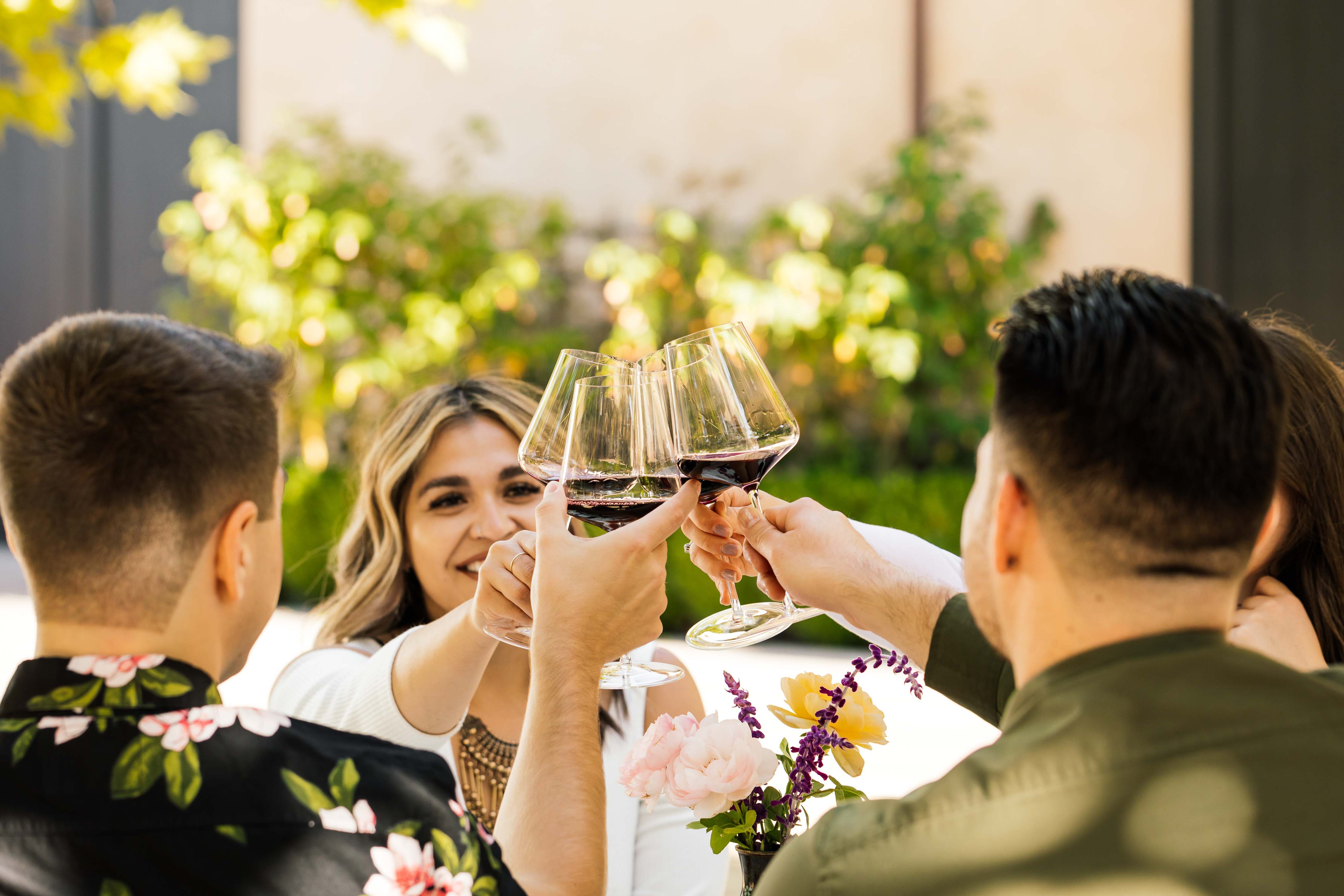 Cheers! Guests of Young Inglewood cheers with glasses of wine outside on a sunny day at Young Inglewood's winery.